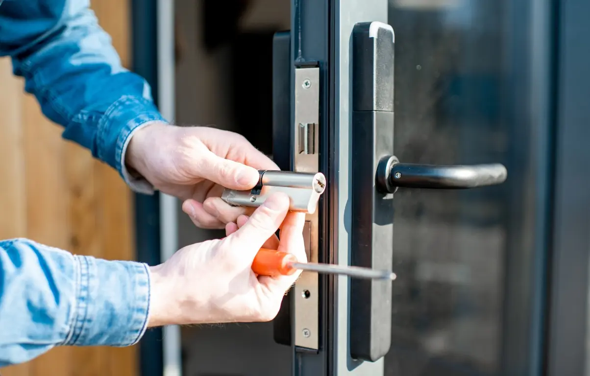 A locksmith changing a glass door lock